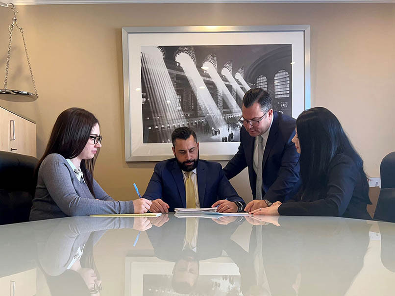 Estate planning attorneys discussing wills, trusts, and legal documents with clients.